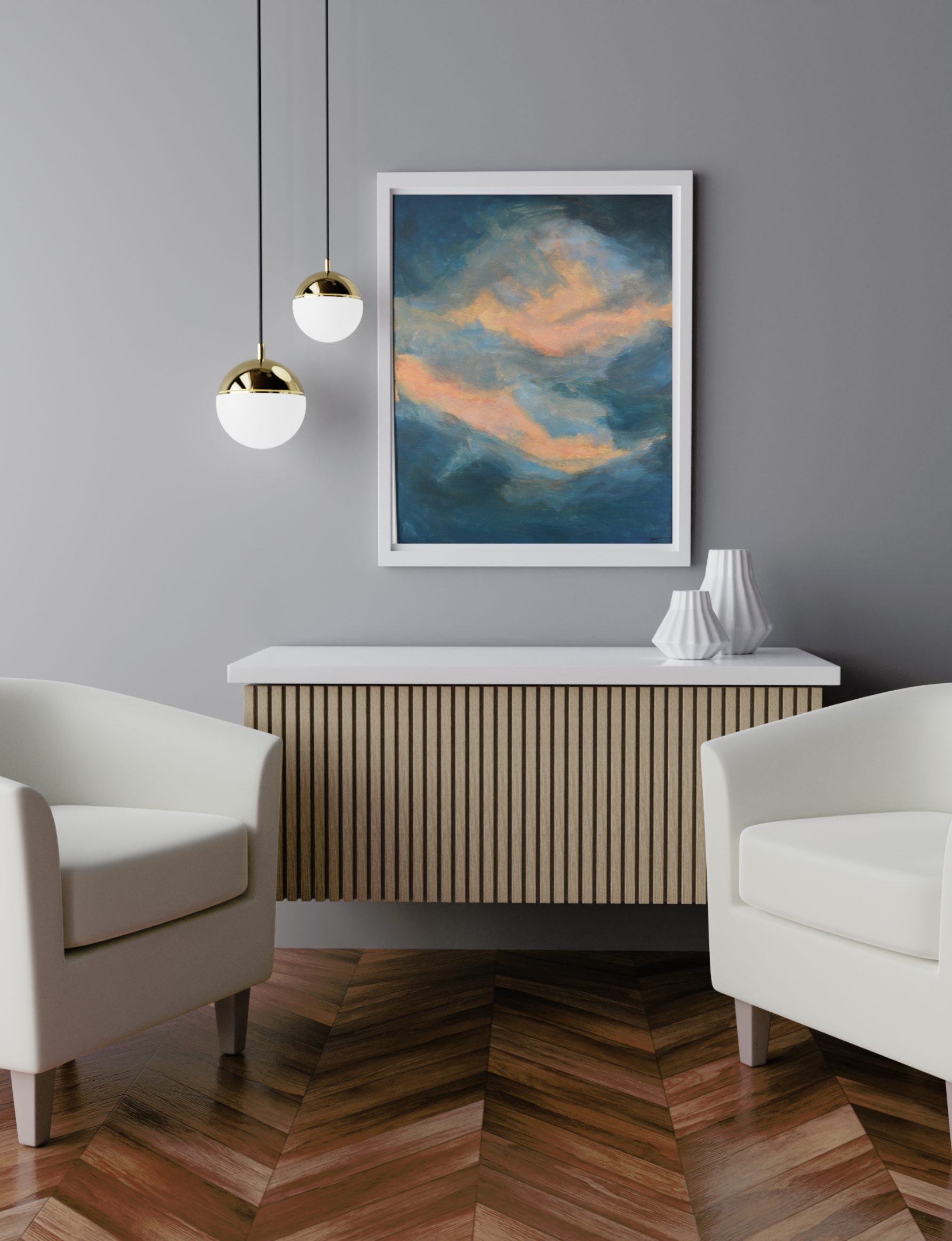 The image features Autumn Dawn 2 painting by Kate Brown presented in a white frame in a room. The painting is just off centre (to the rightO) and has two pendant lights to the left. Below the painting is a white topped console table with white vases atop and slated light wood front. Either side of the table are soft white bucket chairs. The wall is soft grey and the floor is wooden parquet. The image is a mock up to show how the painting would look within a room.